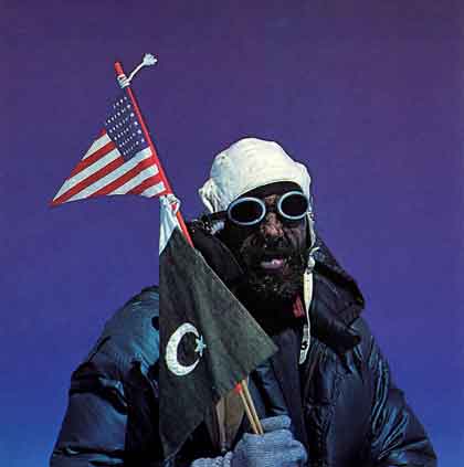 
Gasherbrum I Hidden Peak First Ascent - Andy Kauffman holds the American flag and the Pakistani flag on the summit of Gasherbrum I (Hidden Peak) July 5, 1958
